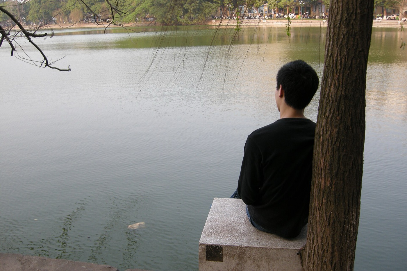 Hoan Kiem Lake in Hanoi with city buildings and water