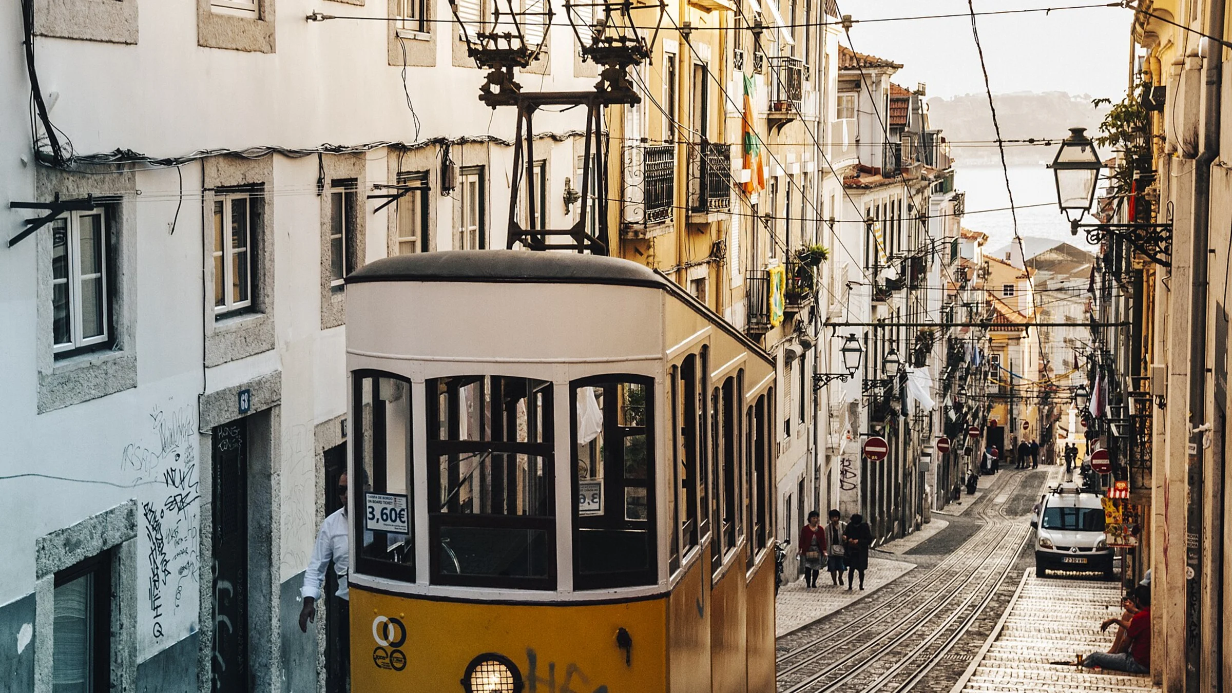 Tram climbing a narrow Lisbon street